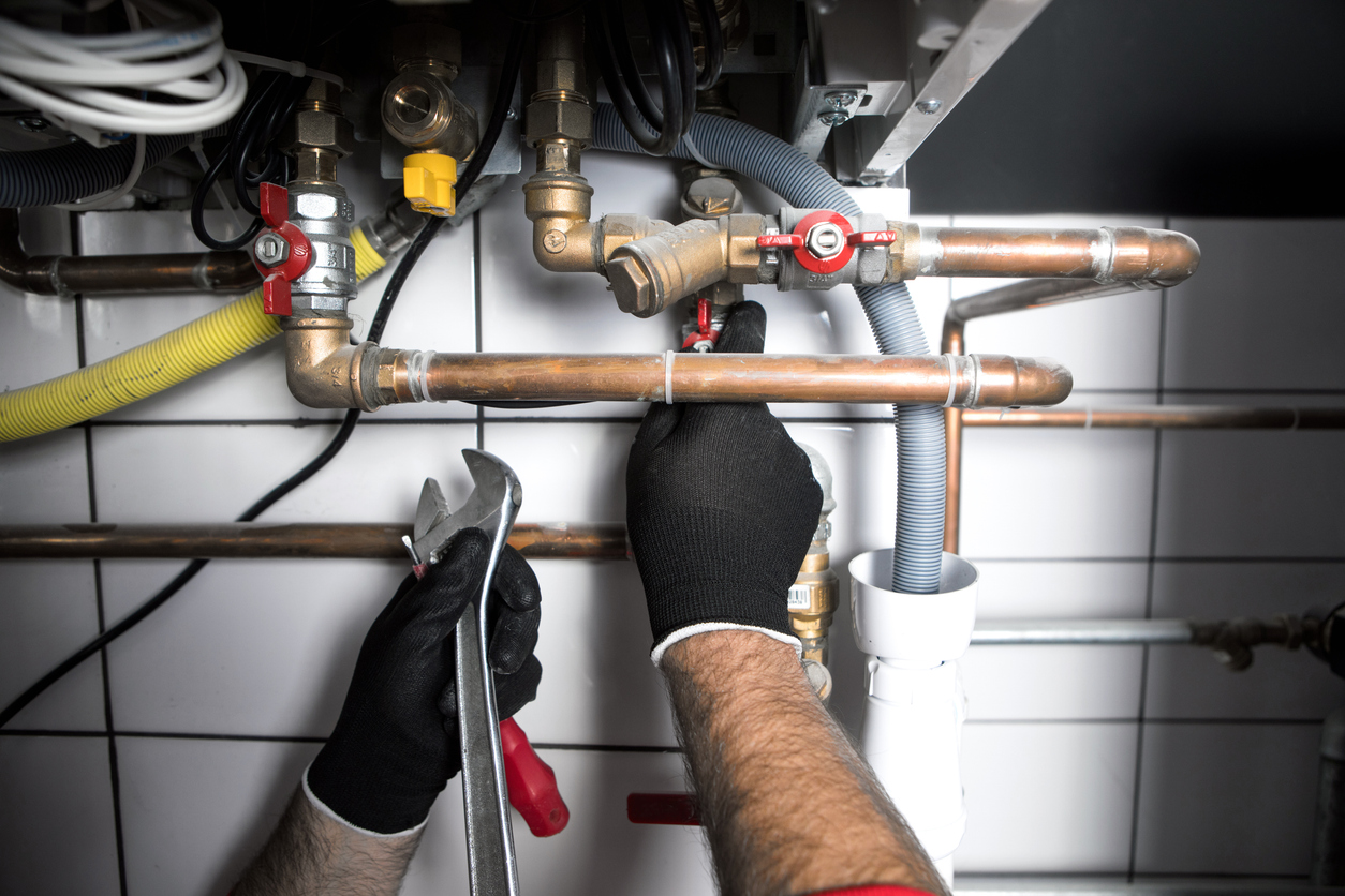 Plumber working on pipe repairs